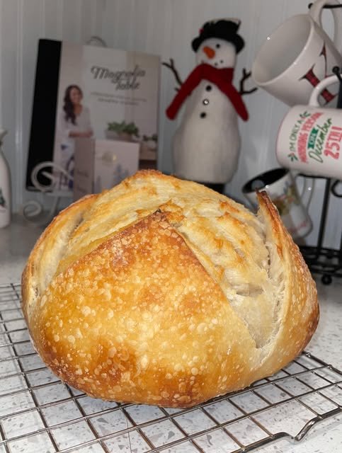 Fresh classic sourdough boule cooling on a rack